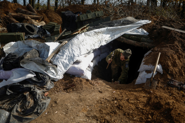 Ukrainian serviceman arranges a dugout at a position in a frontline in Mykolaiv region