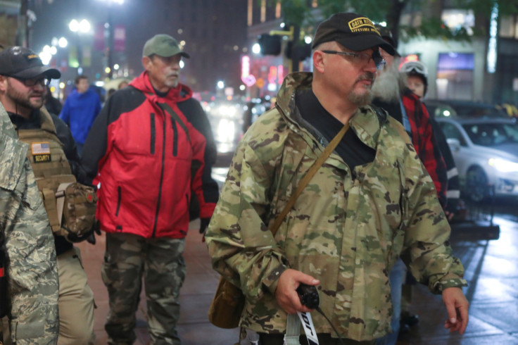 Stewart Rhodes of the Oath Keepers holds a radio as he departs a Trump rally in Minneapolis