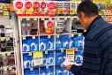 A customer looks at products marked with discounted prices on display at a chemist in a shopping mall in central Sydney