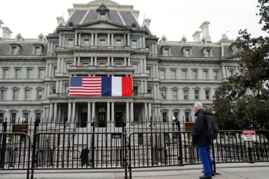 French and US flags adorn the Eisenhower Executive Office Building next to the White House for the state visit of French President Emmanuel Macron who arrives in Washington on November 29, 2022