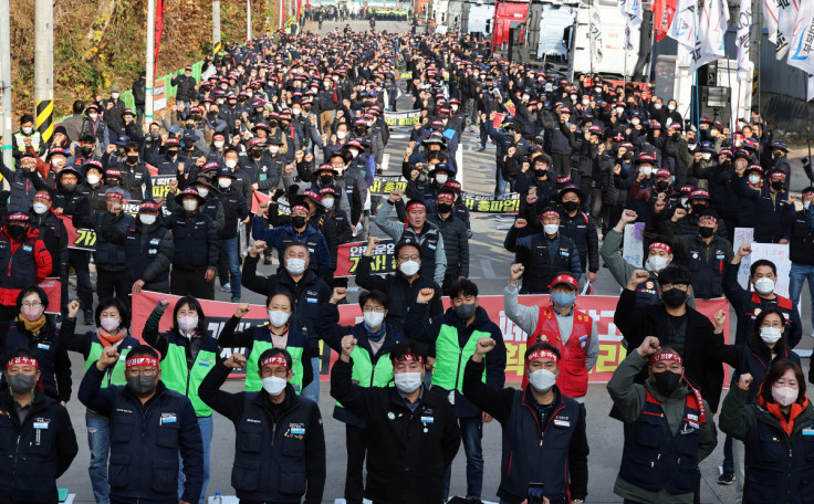 Unionized truckers shout slogans during their rally as they kick off their strike in front of transport hub Uiwang