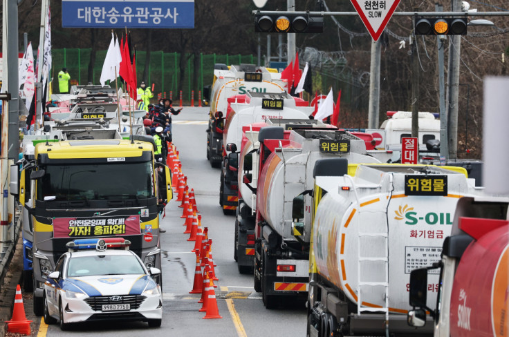 Tankers drive past other tankers taking part in a strike by a truckers' union in Sungnam