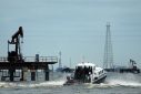 A boat with workers is seen at oil field at Venezuela's western Maracaibo lake