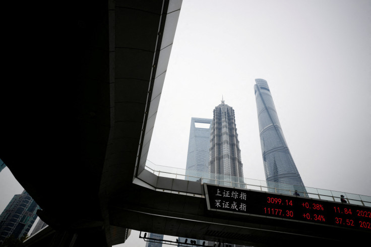 An electronic board shows Shanghai and Shenzhen stock indexes in Shanghai