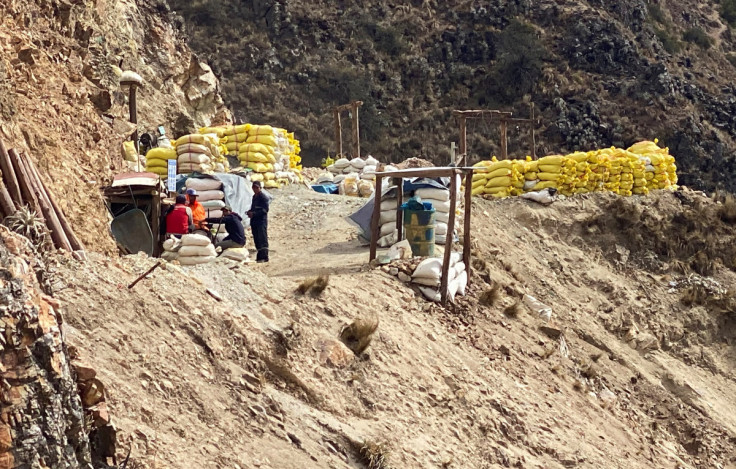 Artisan miners stand in an area where hundreds of artisan miners have found a rich seam of copper in Peru