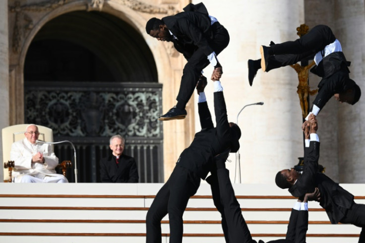 Pope Francis watches Kenyan circus artists perform during his weekly general audience at the Vatican on Wednesday