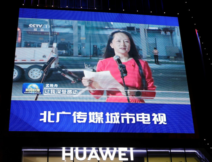 A giant screen on top of a Huawei store shows images of Huawei Technologies Chief Financial Officer Meng Wanzhou, while broadcasting a CCTV state media news bulletin, outside a shopping mall in Beijing