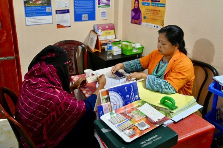 A health worker explains birth control methods to a Rohingya refugee in the maternity ward of a medical centre in the Kutupalong refugee camp