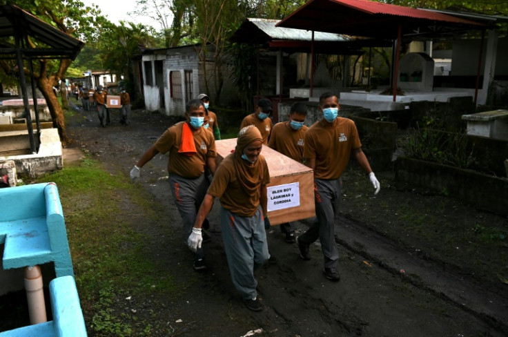 The bodies of 70 inmates from the Philippines' largest prison were laid to rest Friday in a mass burial, weeks after their decomposing remains were discovered in a Manila funeral home