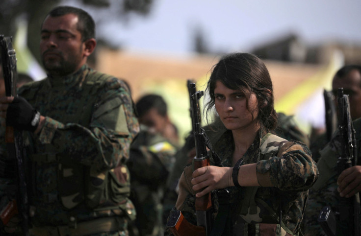 A fighter of Syrian Democratic Forces (SDF) holds her weapon as they announce the destruction of Islamic State's control of land in eastern Syria
