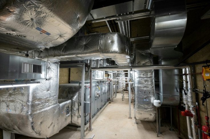 This energy-efficient system sucks warm air from outside to heat air/water inside the building