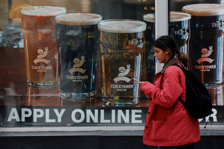 A sign advertising available jobs at the Clocktower Brew Pub hangs in a window in Ottawa