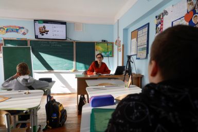 Teacher conducts a hybrid mathematic lesson for junior students of a private school in Kyiv