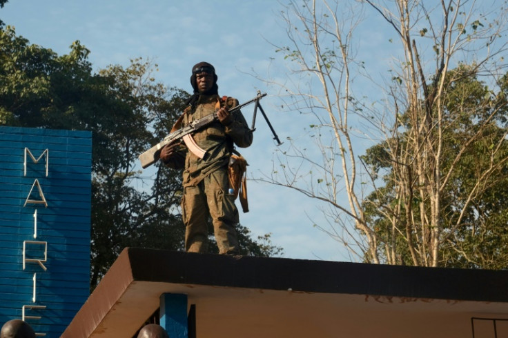 A Central African Republic soldier guards the town hall in Bambari in November 2020 as order is restored after years of clashes between Christian and Muslim militias