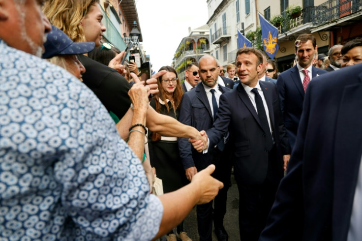 French President Emmanuel Macron greets people in the historic French Quarter of New Orleans, Louisiana, on December 2, 2022