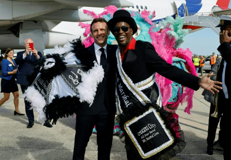 French President Emmanuel Macron is welcomed by members of the Crescent City All Star Band upon arrival in New Orleans  on December 2, 2022