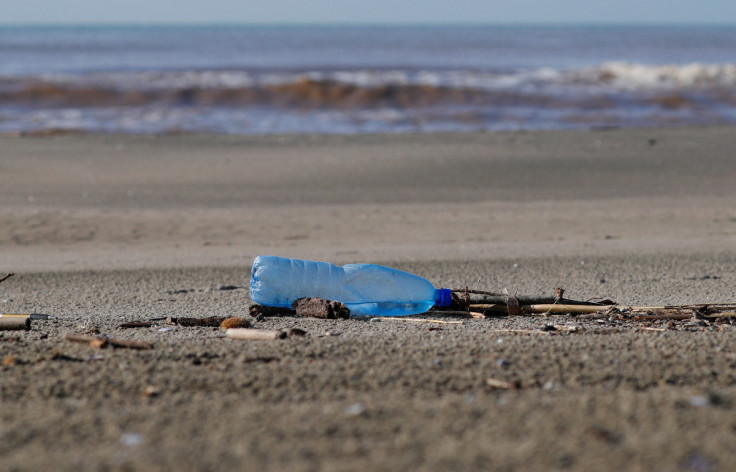 A plastic bottle lies on the sand at Maccarese beach in Italy