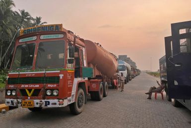 Supply trucks carrying construction materials for the proposed Vizhinjam Port are parked near the port
