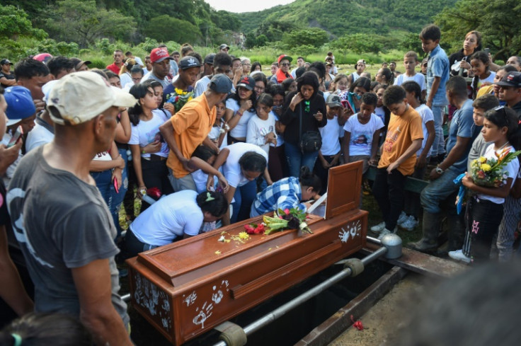 Yadimar Sierra, killed in a Caracas shooting blamed by relatives on the police, is laid to rest on November 21, 2022, as her mother, Jenny Arriaza Elias, cries over her coffin