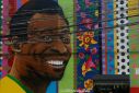 View of a mural depicting Brazilian football legend Pele by artist Aleksandro Reis in Sao Paulo on Saturday