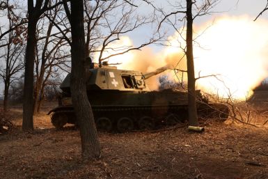 Ukrainian service members fire an artillery piece in the Donetsk region