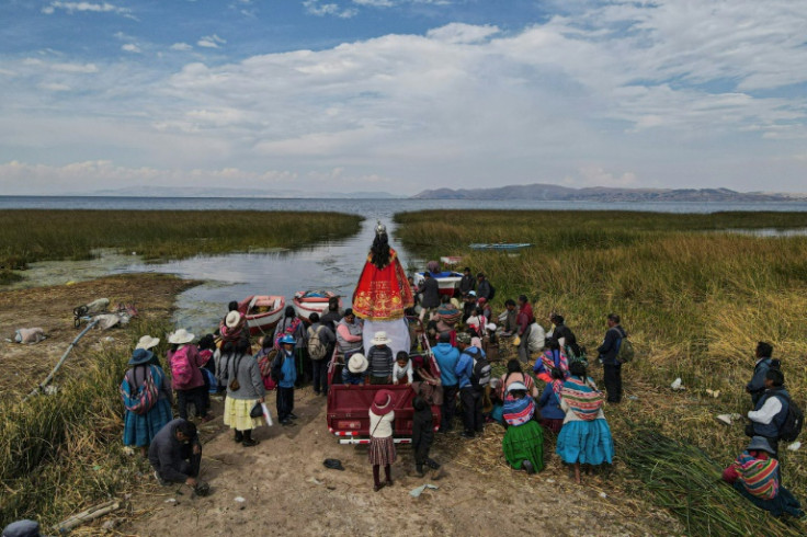 Aymara-speaking peasant farmers take part in a religious procession to pray for rain near the village of Ichu in southern Peru