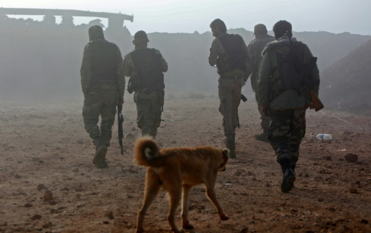 Turkish-backed Syrian fighters return to base after conducting a patrol near the front line with Kurdish forces in Tal Rifaat