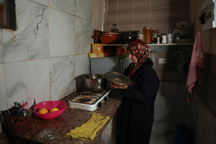 Wife of unemployed Lebanese Hussein Hamadeh stands at the kitchen of her home, in Beirut
