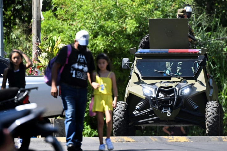 An armored car patrols in a gang-ruled neighborhood called La Campanera