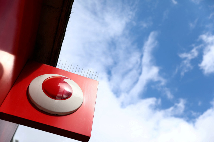 A branded sign is displayed on a Vodafone store in London