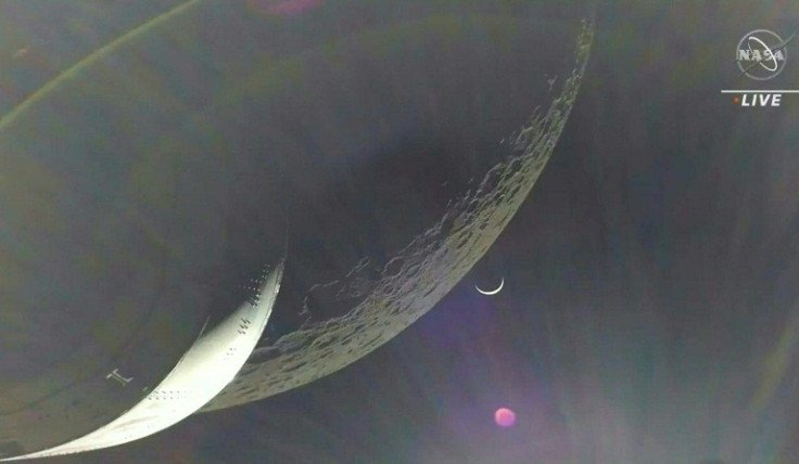 Earth is visible as a crescent in the minutes after Orion finished its engine burn around the Moon