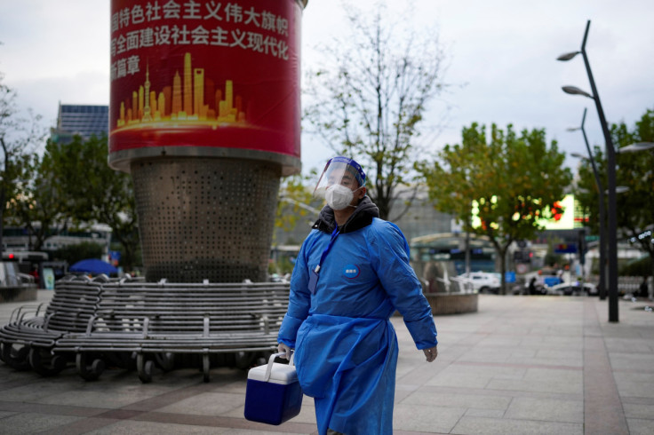 A worker in protective suit walks, as coronavirus disease (COVID-19) outbreaks continue in Shanghai