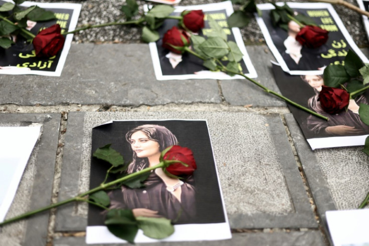 Flowers lay on portrait of Mahsa Amini at a demonstration  in front of the Iranian embassy in Brussels, on September 23, 2022