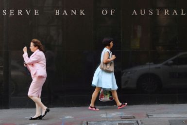 Two women walk next to the Reserve Bank of Australia headquarters in central Sydney