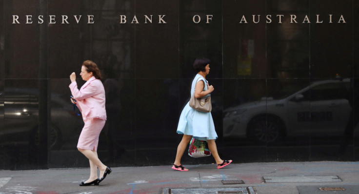 Two women walk next to the Reserve Bank of Australia headquarters in central Sydney