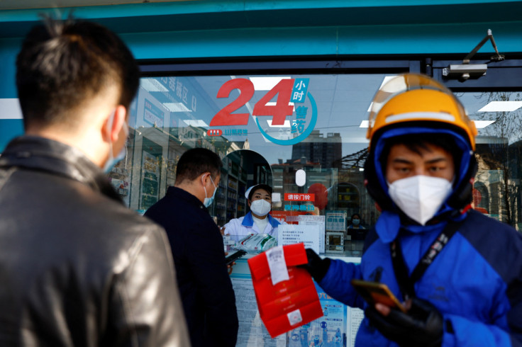People line up to buy fever and cold medicine in Beijing