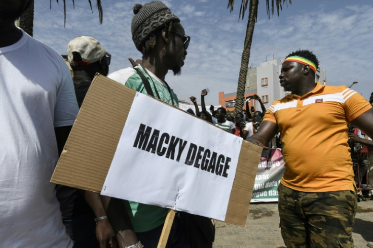 Tension: A protester in Dakar in June, holding a sign calling for President Macky Sall to quit