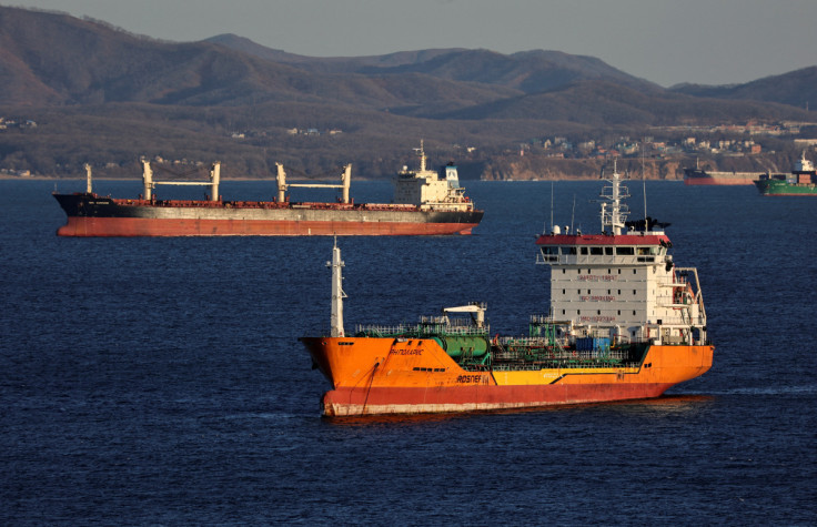 A crude oil tanker and a bulk carrier sail in Nakhodka Bay