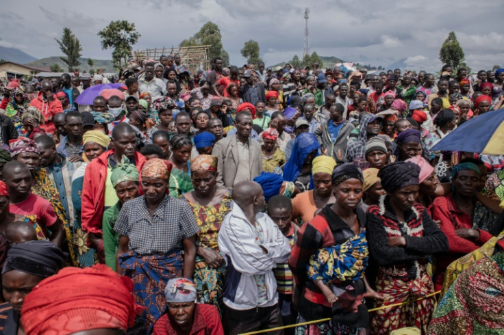People displaced by the fighting in eastern DR Congo await a distribution of aid by UNICEF