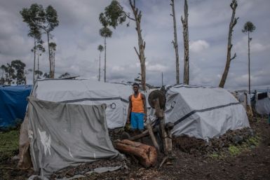 Diela Bazi, 20, a secondary-school student, next to his shelter. He looks after his siblings after they were separated from the rest of the family during their escape from their home in the village of Rugari