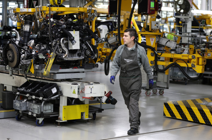 A staff member works on an engine block inside the Bentley factory in Crewe