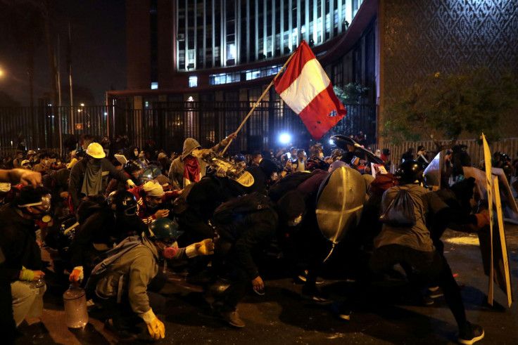 Demonstrators clash with police during protests that led to the resignation of Peru's interim President Manuel Merino, in Lima