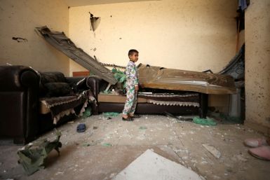 A Palestinian boy in a damaged home after a raid by Israeli force in Jenin