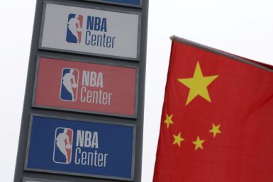NBA logos are seen next to a Chinese national flag outside a NBA-themed lifestyle complex on the outskirts of Tianjin