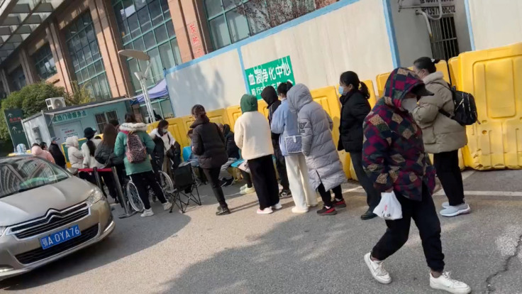 People wait outside a hospital in Wuhan