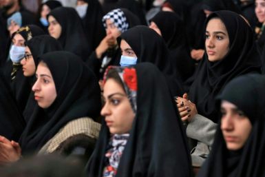 This handout picture provided by the Iranian presidency shows students listening to Iran's President Ebrahim Raisi at Tehran University during student day celebrations on December 7