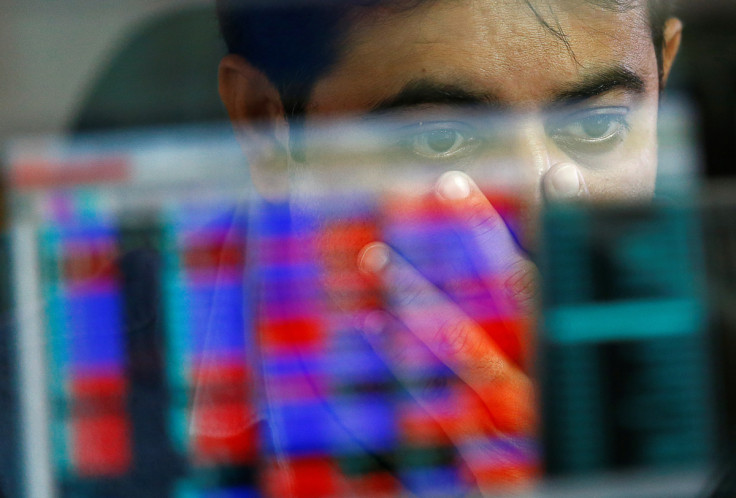 A broker reacts while trading at his computer terminal at a stock brokerage firm in Mumbai