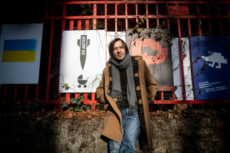 Ukrainian graphic designer Mykola Kovalenko with some of his posters in Bratislava, Slovakia