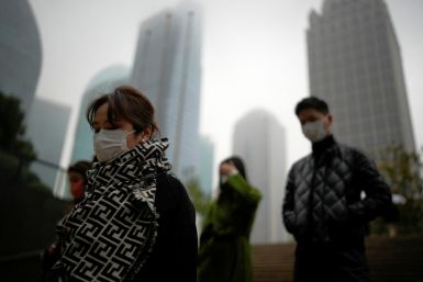 People wearing masks walk as coronavirus disease outbreaks continue in Shanghai