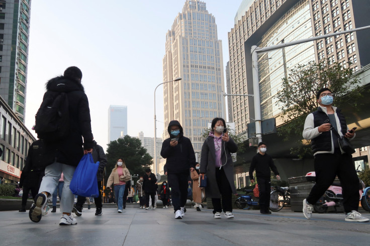 People walk on a street during morning rush hour in Wuchang district, after the government gradually loosened restrictions on coronavirus disease (COVID-19) control, in Wuhan, Hubei